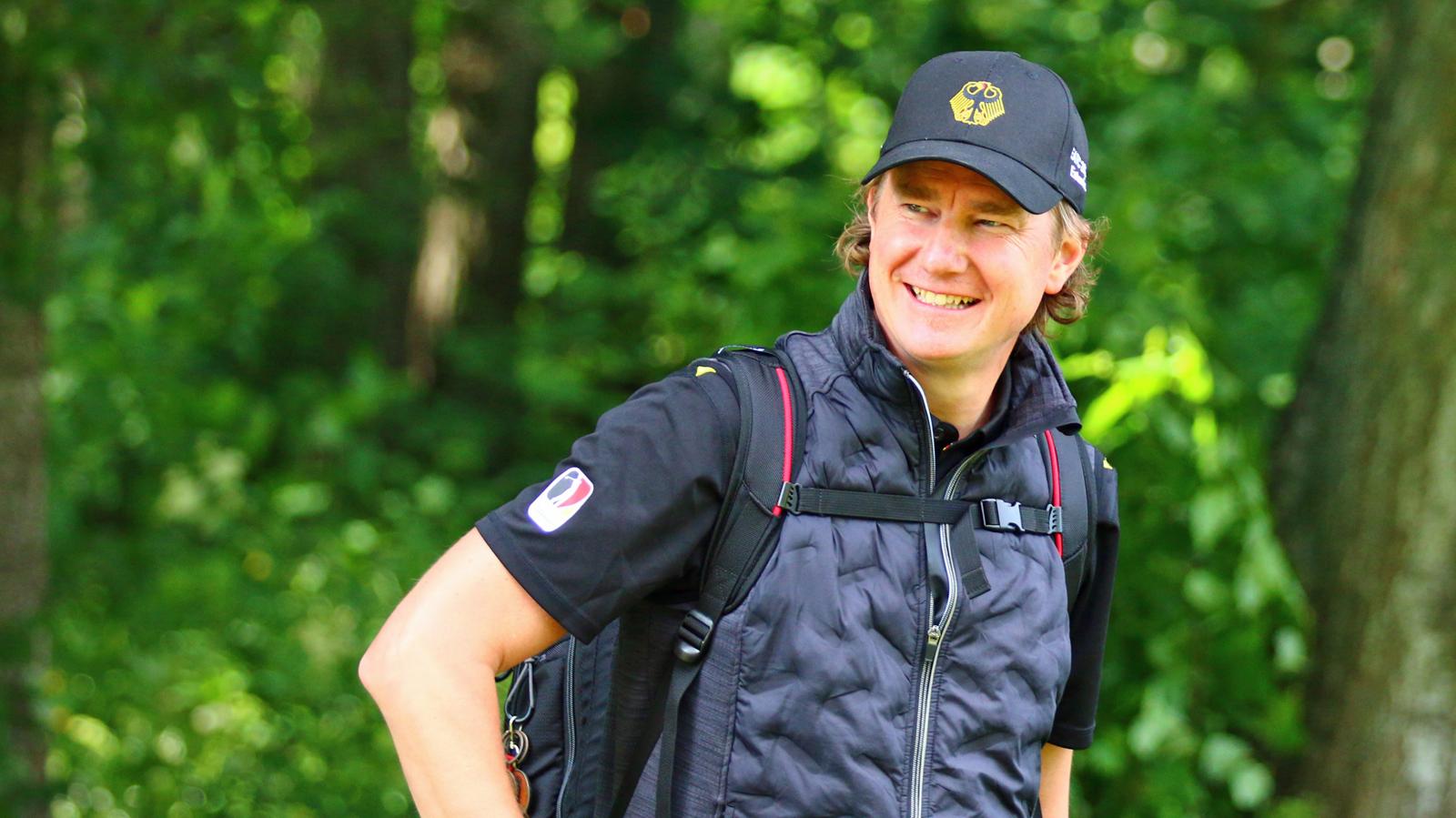 Matthias Althoff, Head of Performance for Team Germany, wearing a Team Germany cap on a tree-lined course